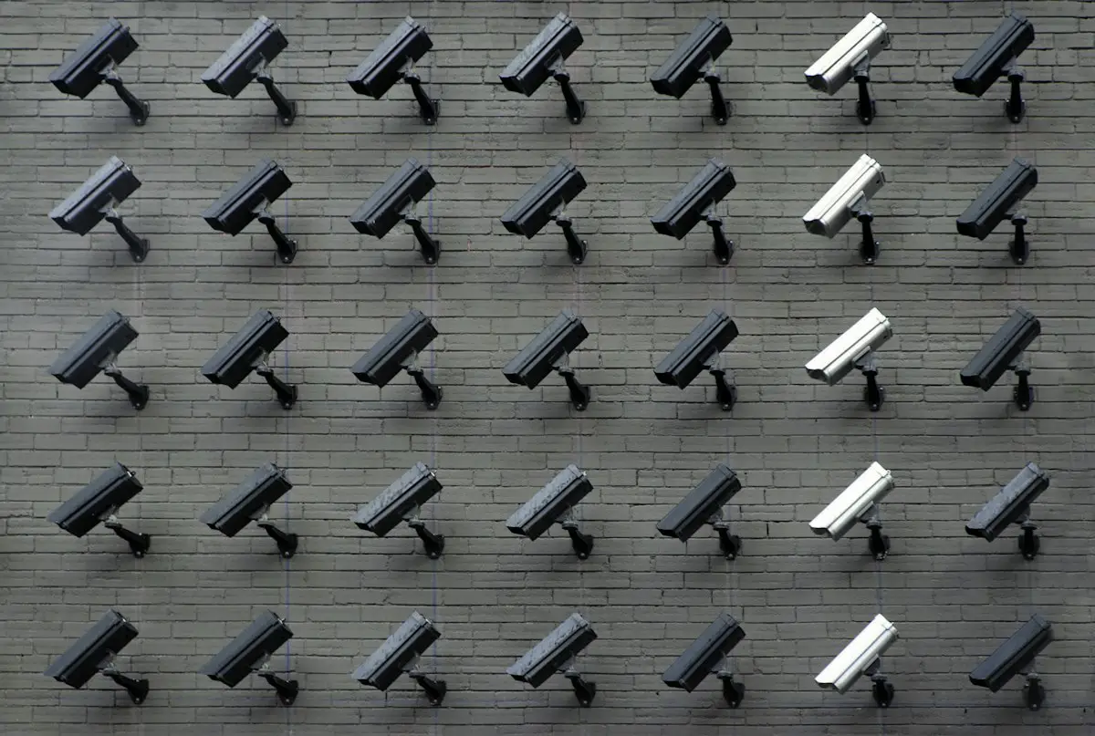 Rows of security cameras on a wall