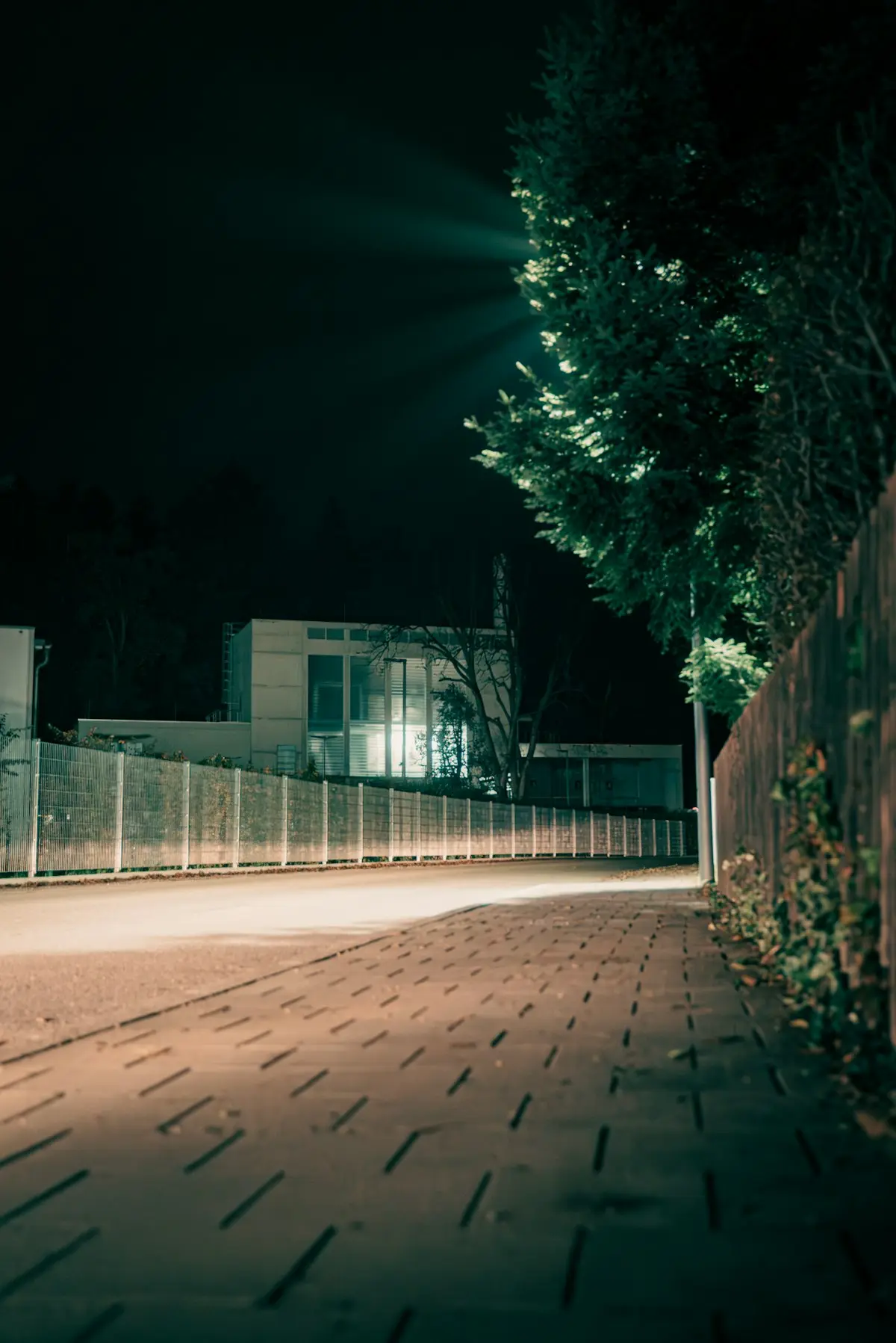 Perimeter fence and building lit at night
